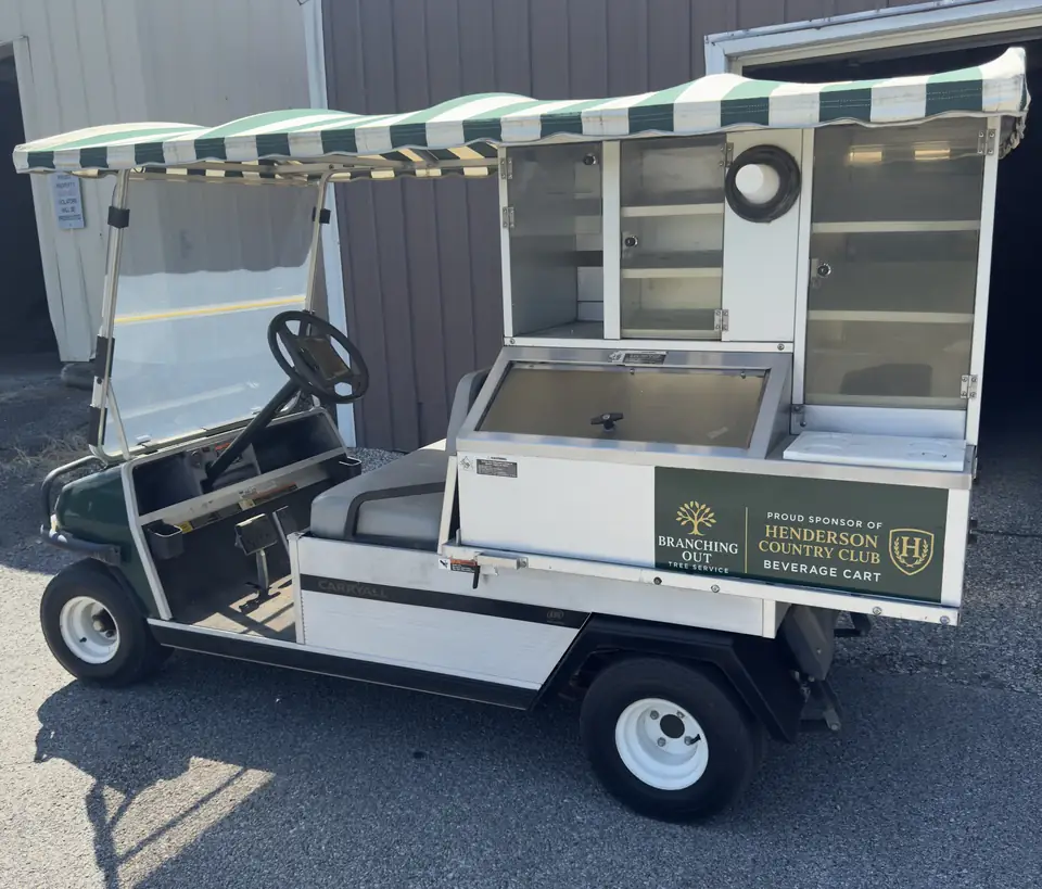 Henderson Country Club beverage cart displaying Branching Out Tree Service sponsorship