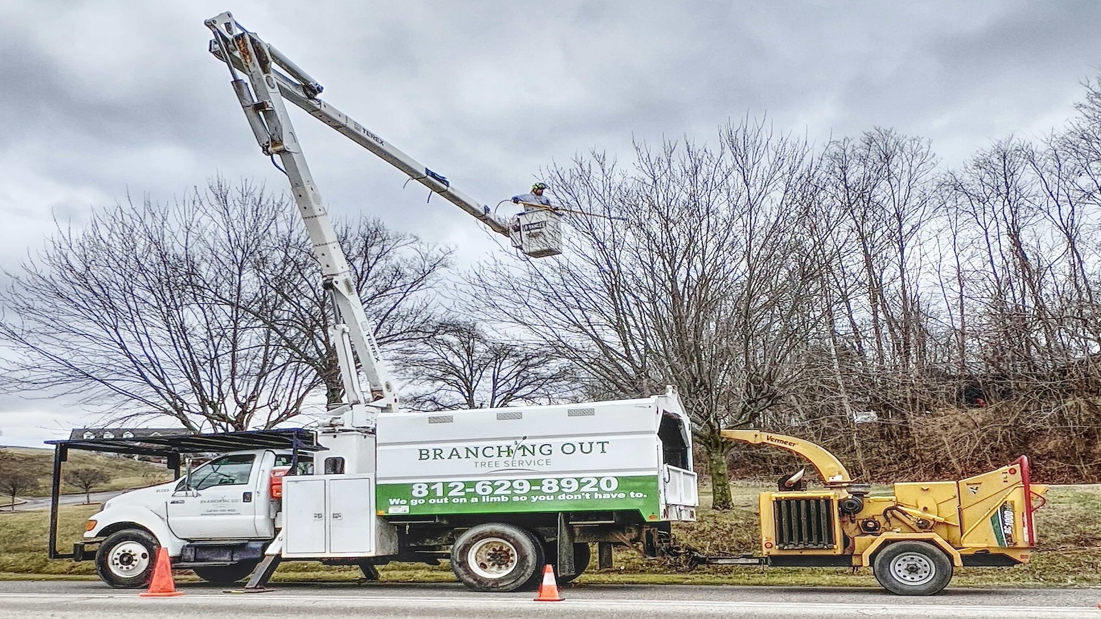 Branching Out bucket truck and chipper working in Newburgh